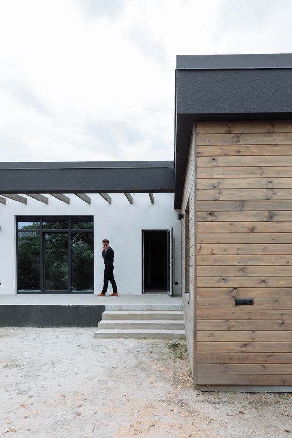 Real estate professional outside a modern home